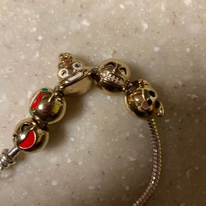Silver colored bracelet with gold colored emojis beads lobster clasp with heart